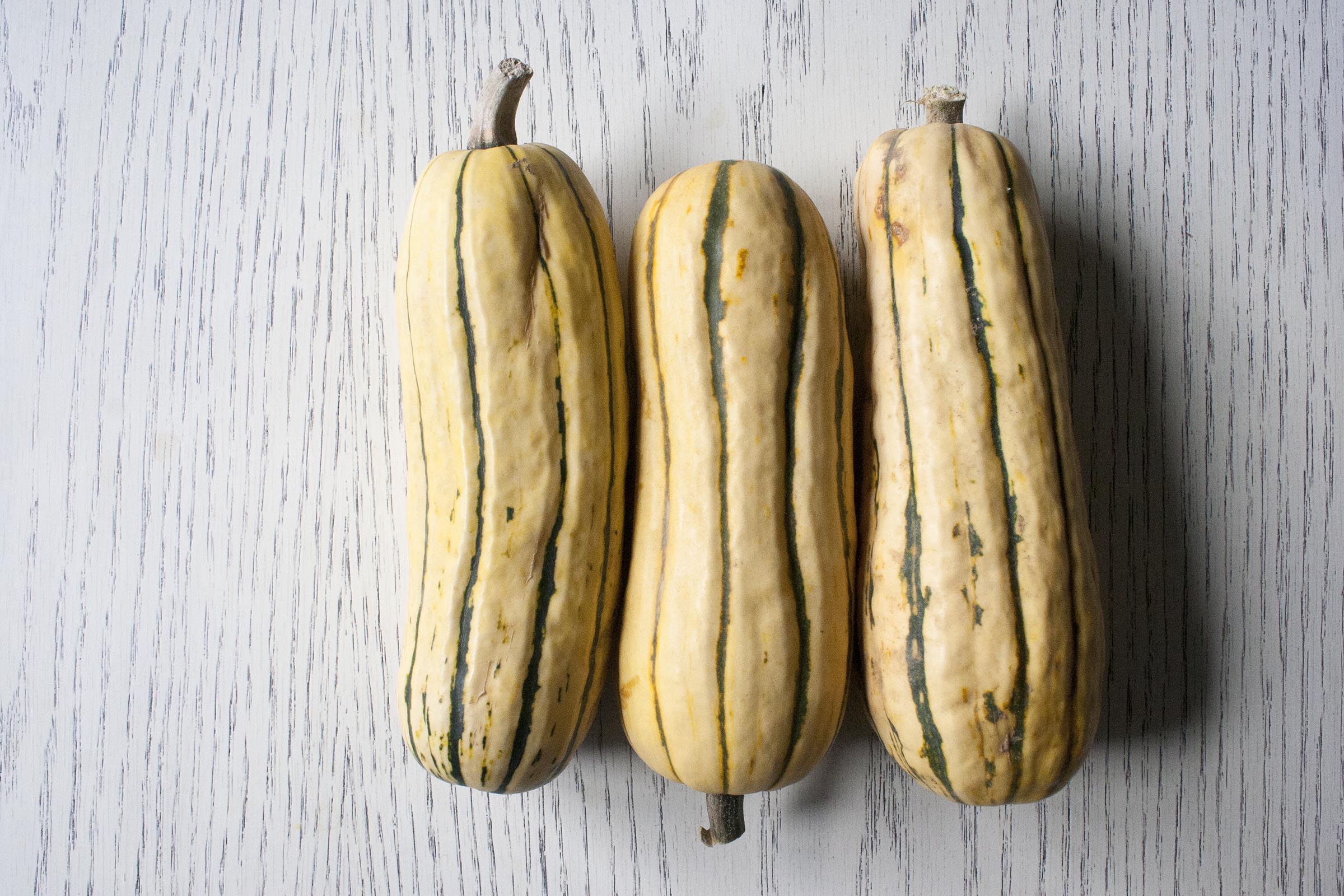 Three similarly sized delicata squash.