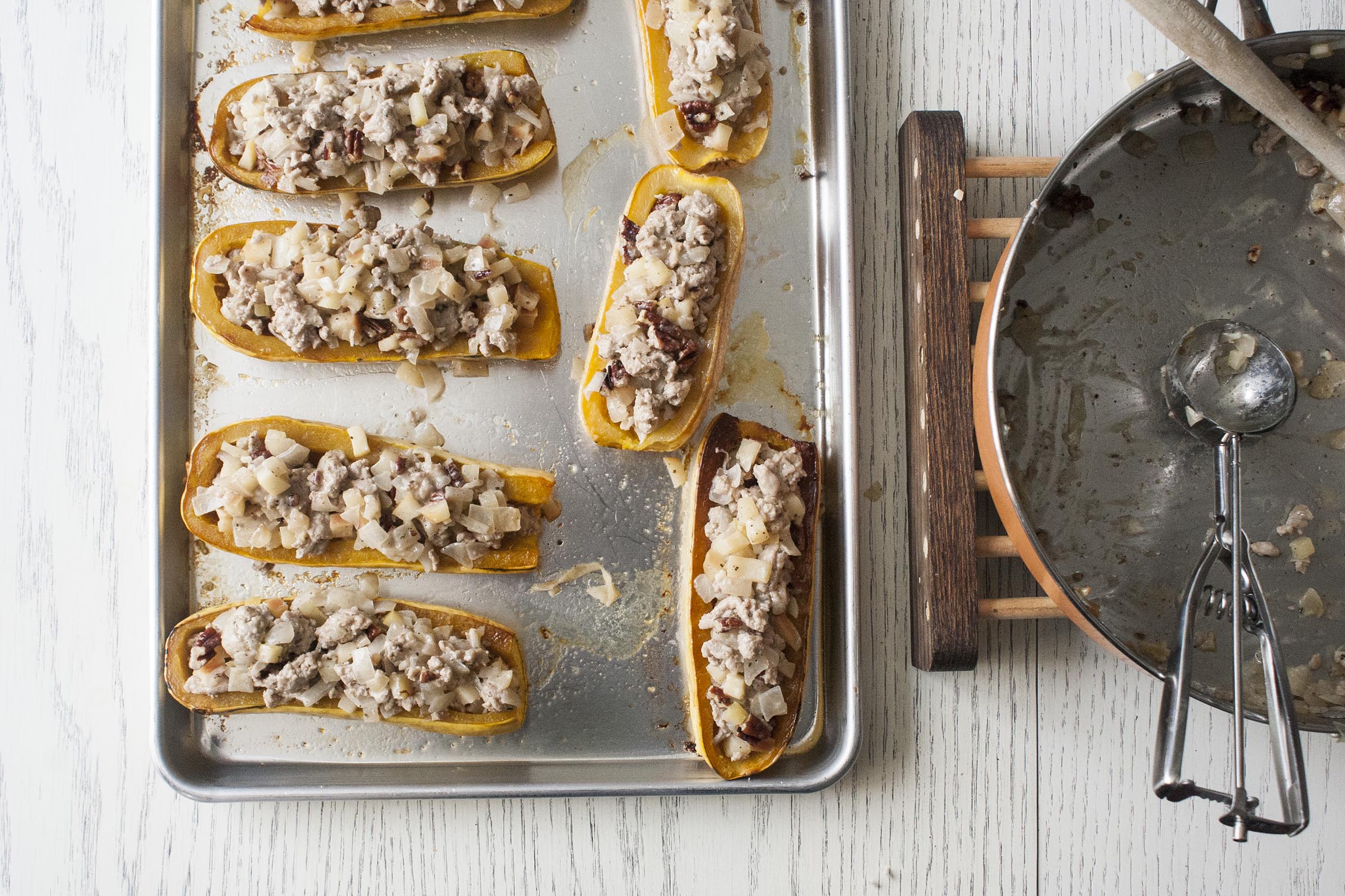 These delicata squash have been halved, roasted and stuffed with a filling of ground turkey, apples and pecans.