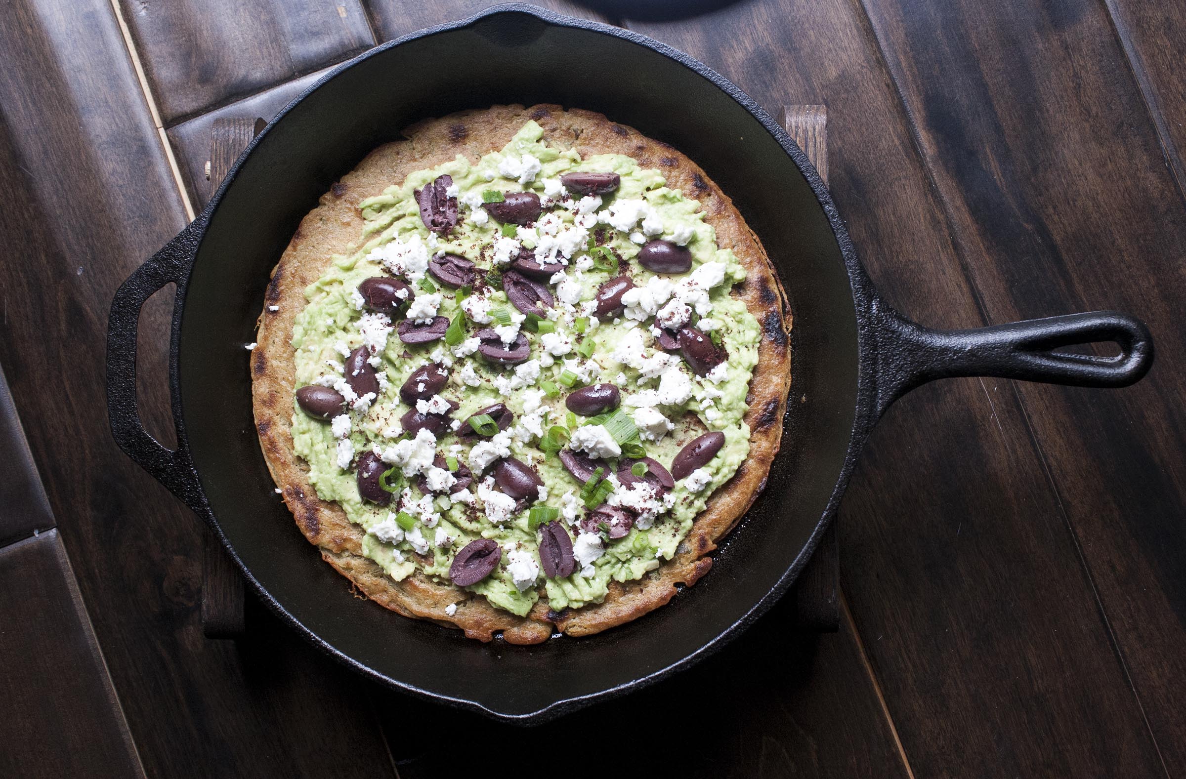 Sumac Socca batter is laced with sliced scallions and broiled until golden, then topped with smashed lemony avocado, briny olives and creamy sheep's milk feta. I lifeaswecookit.com