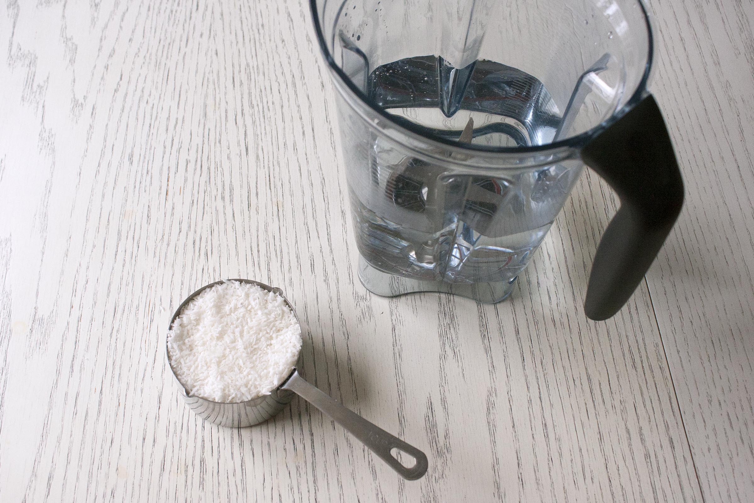 Unsweetened Coconut and Water in Vitamix for Homemade Coconut Milk Recipe. www.lifeaswecookit.com