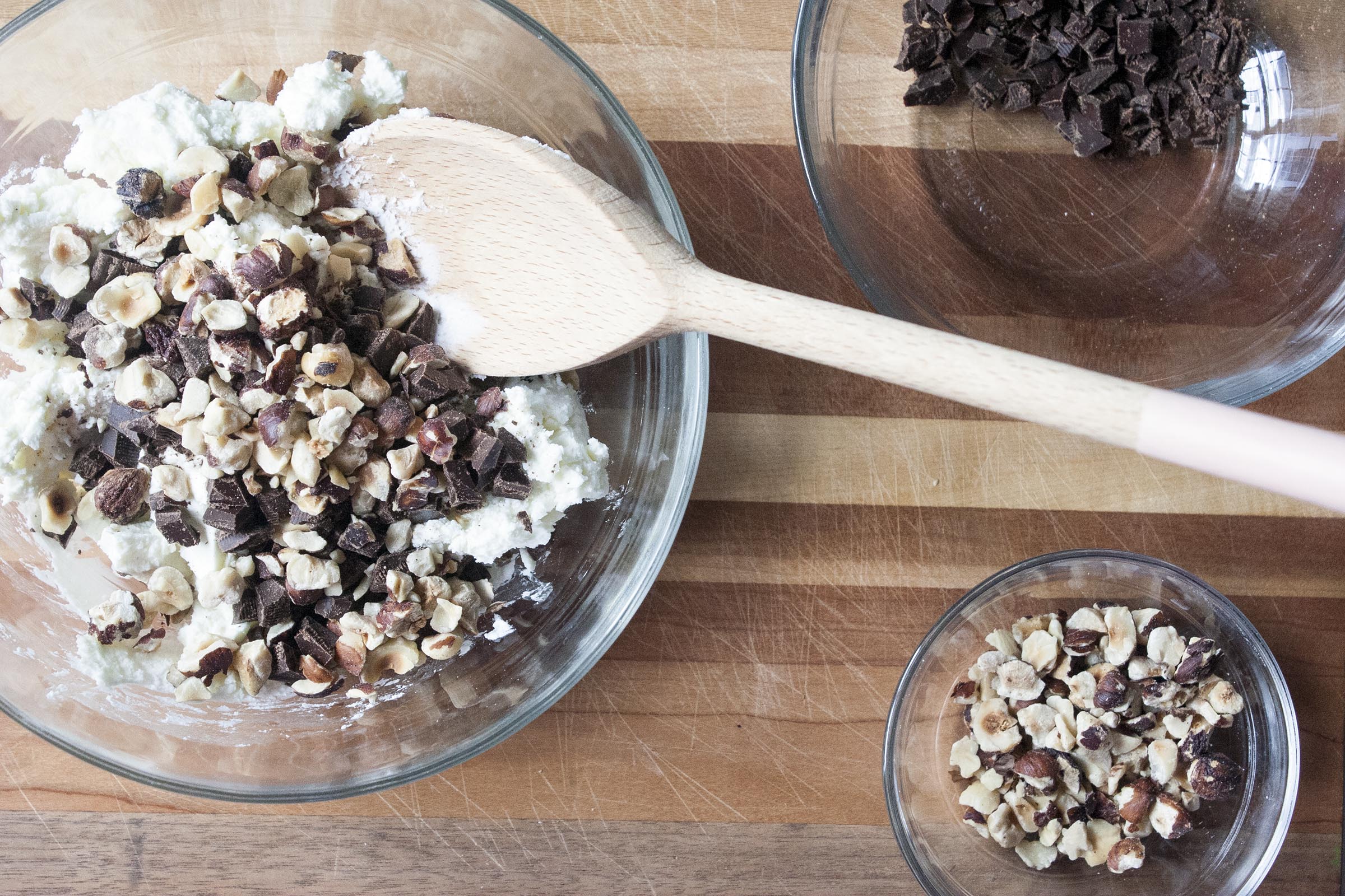 Stirring together four ingredient Chocolate Hazelnut Goat Cheese Truffles. www.lifeaswecookit.com