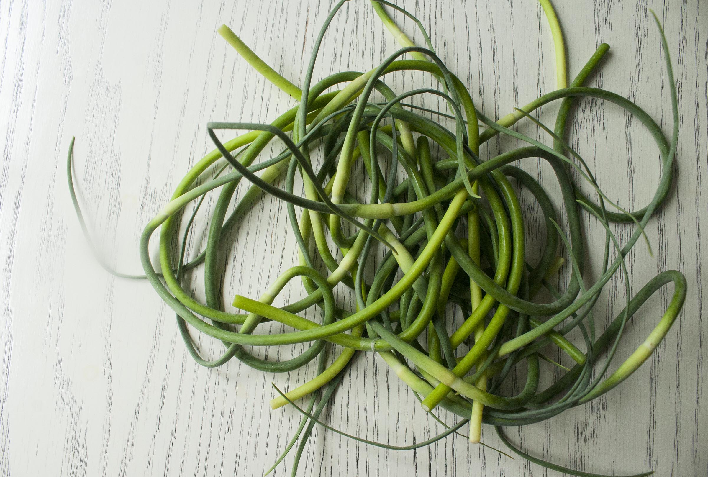 Garlic Scapes from the Farmers Market for Garlic Scape & Hemp Seed Pesto. www.lifeaswecookit.com