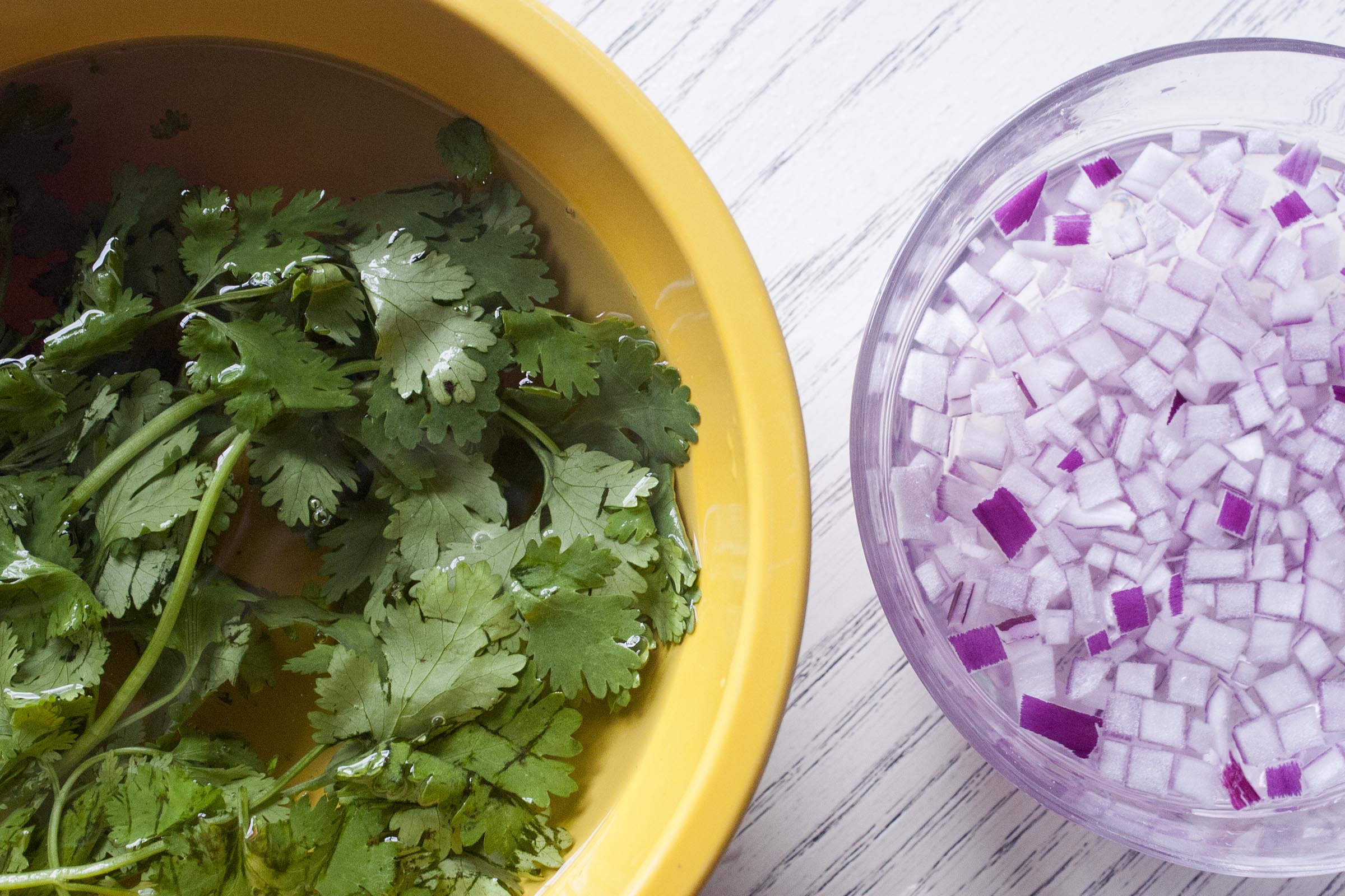 Soaking Cilantro and Red Onions to remove grit and sharpness for Fresh Tomatillo & Avocado Salsa. www.lifeaswecookit.com