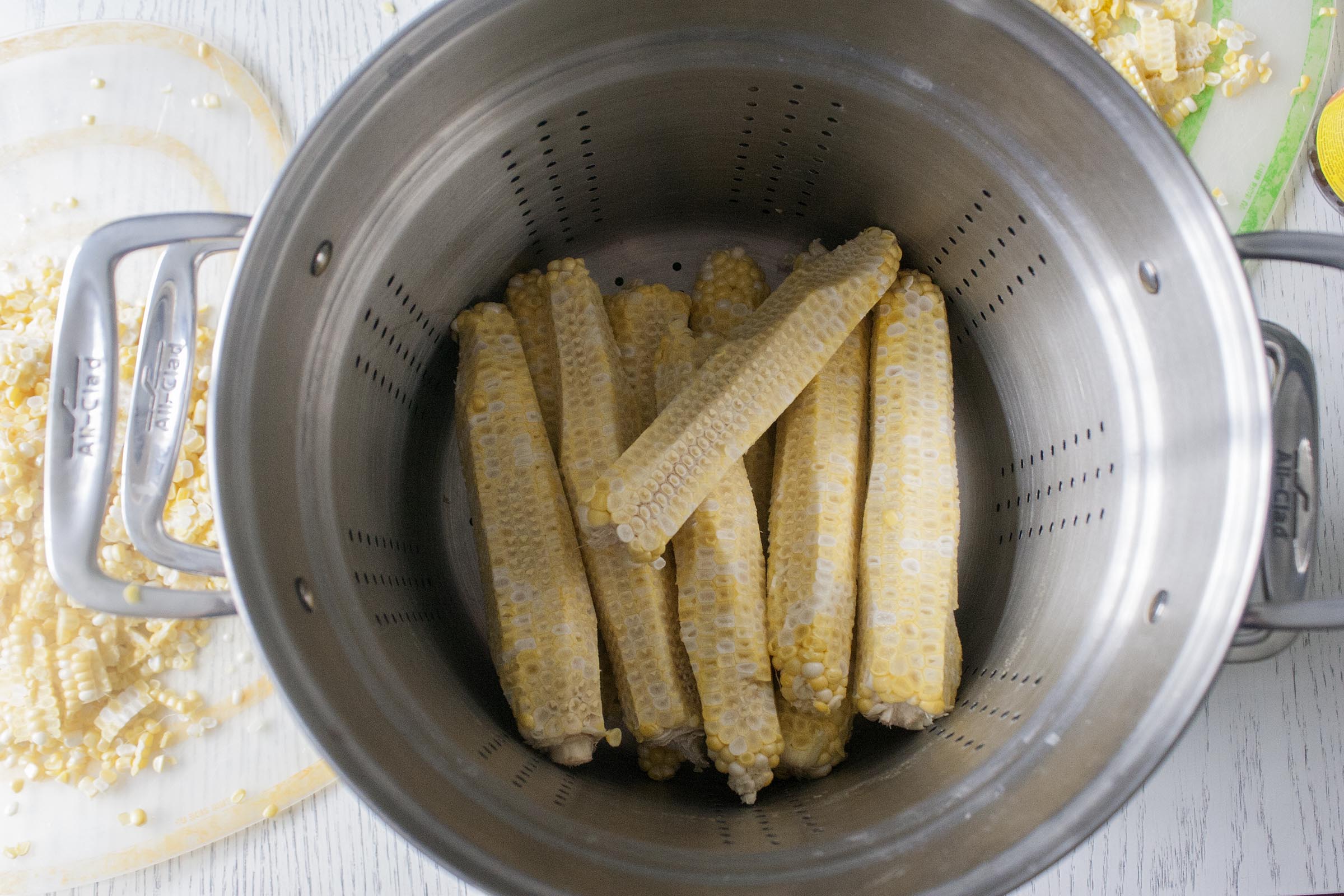 Stripped corn cobs heading into the pot. Add water, simmer and strain: corn stock! www.lifeaswecookit.com