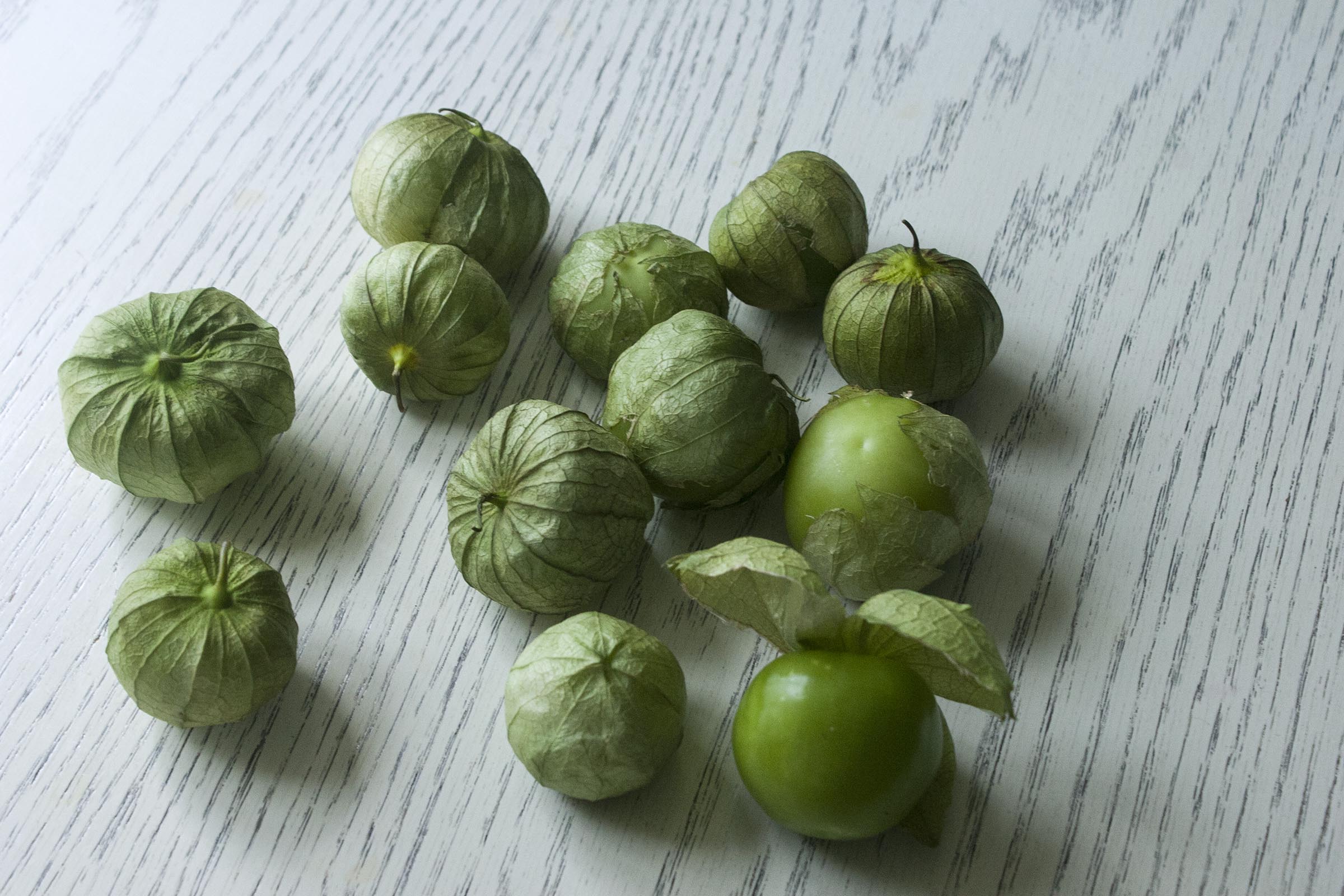 Tomatillos not yet husked for Fresh Tomatillo & Avocado Salsa. www.lifeaswecookit.com