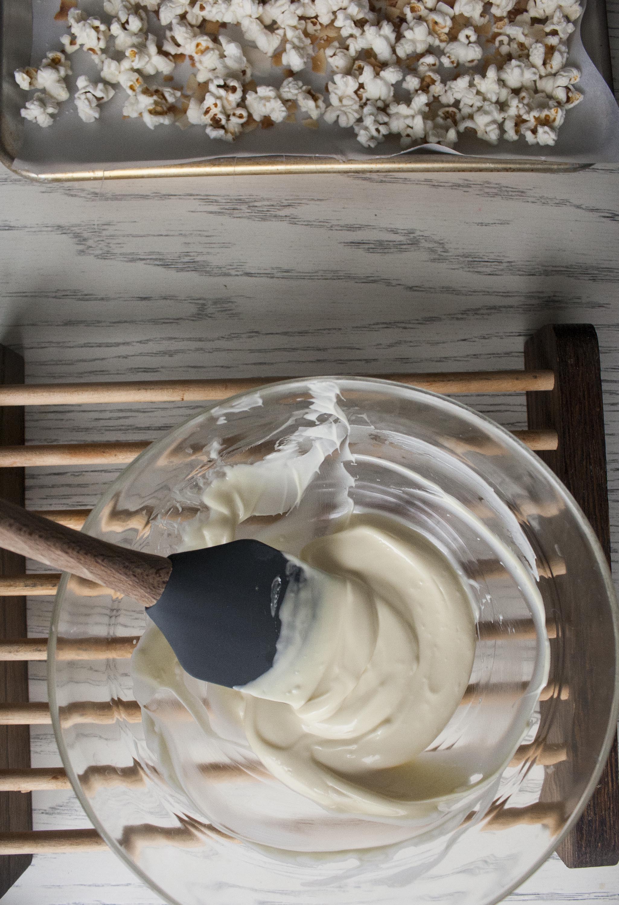 Fully Melted White Chocolate for Coconut and Raspberry-Drizzled White Chocolate Popcorn. www.lifeaswecookit.com