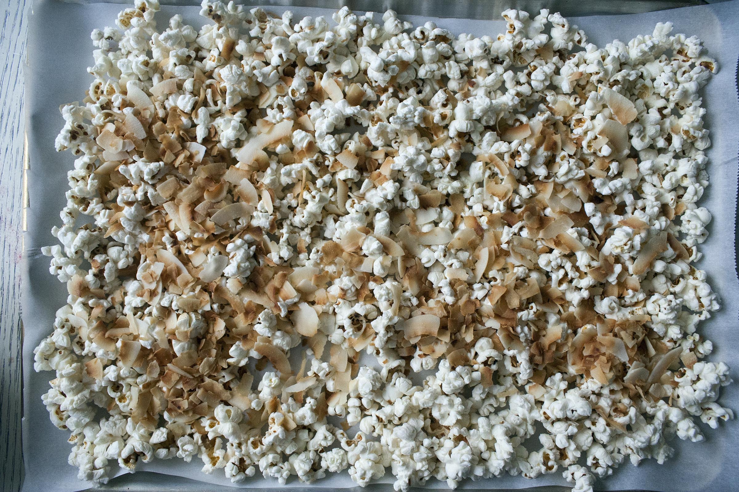 Popped Popcorn, Kosher Salt and Toasted Coconut Flakes for Coconut and Raspberry-Drizzled White Chocolate Popcorn www.lifeaswecookit.com